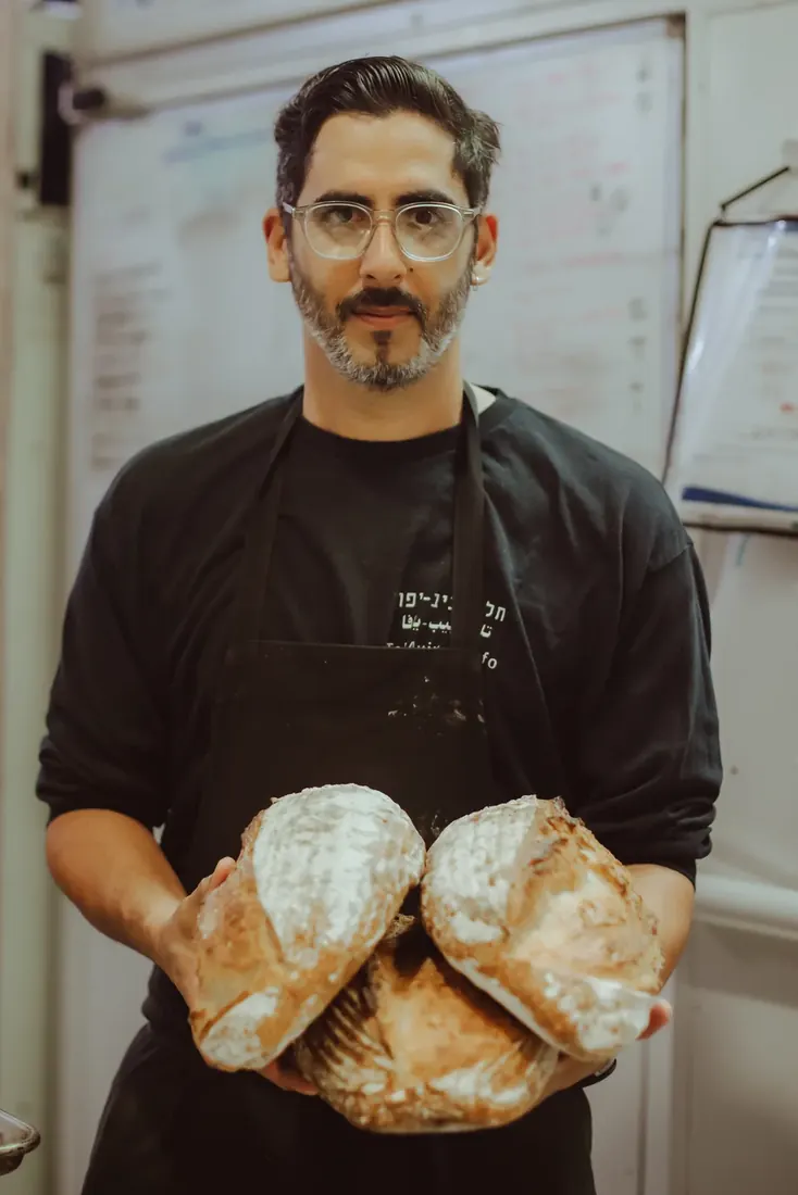 Roy Chason with freshly baked bread in the Tel Aviv Yafo kitchen